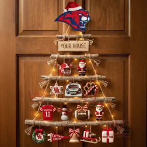 A rustic wooden branch Christmas wall tree decorated with Houston Cougars ornaments and warm lights hanging on a wooden door!
