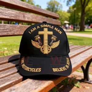 Black cap with gold faith embroidery resting on a park bench in daylight!
