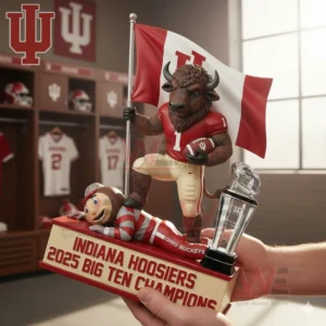 Hands holding an Indiana Hoosiers bison mascot collectible with a flag football rival character and trophy on a Big Ten Champions base in a team locker room.