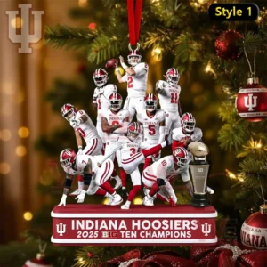 Indiana Hoosiers football players in white uniforms posed together on a championship ornament base with a trophy beside them.
