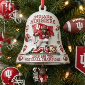 Bell ornament featuring the Indiana Hoosiers mascot with a flag over a rival and a smaller figure holding a championship trophy surrounded by holiday tree decorations.