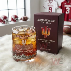 A whiskey glass decorated with Indiana Hoosiers championship graphics placed beside a matching printed box on a soft surface!