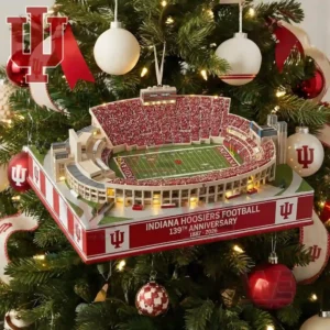 A realistic miniature Indiana Hoosiers football stadium with bright lights and crowded stands hangs as a Christmas tree ornament surrounded by team colored decorations!