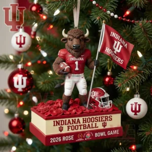 An Indiana Hoosiers mascot ornament holding a football and flag standing on a Rose Bowl themed base hanging on a decorated Christmas tree!