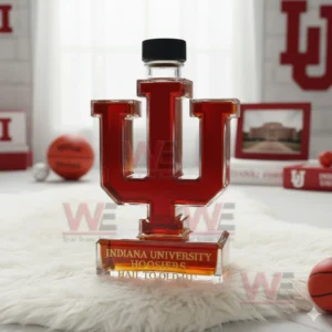 Indiana University Hoosiers IU shaped whiskey bottle with amber liquid and black cap displayed on white fur!