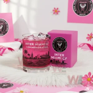 Pink whiskey glass with ice and Miami football design displayed on white fur with matching pink box!