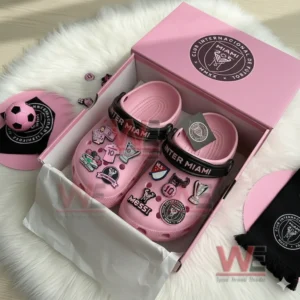 Inter Miami Crocs Clogs with Charms 5 Pink Inter Miami clogs inside a pink box decorated with assorted soccer themed charms.