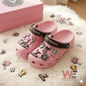 Inter Miami Crocs Clogs with Charms 6 Pink Inter Miami clogs on a white rug surrounded by loose decorative charms.