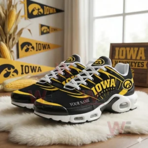 Black and yellow Iowa Hawkeyes sneakers with team logos and customizable name text displayed in a decorated fan themed setting!