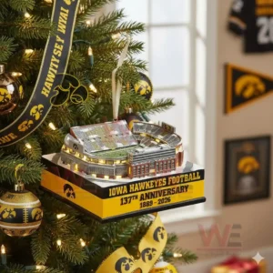 Iowa Hawkeyes football stadium anniversary ornament hanging at the center of a Christmas tree with black and gold decorations!