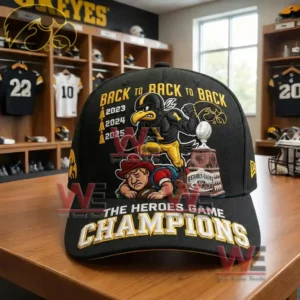 Black Iowa Hawkeyes cap with embroidered mascot trophy and champions text shown in a locker room.