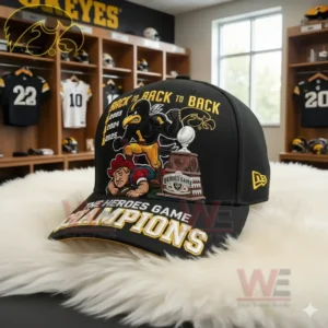 Angled Iowa Hawkeyes cap with embroidered mascot and trophy displayed on a white surface in a locker room.