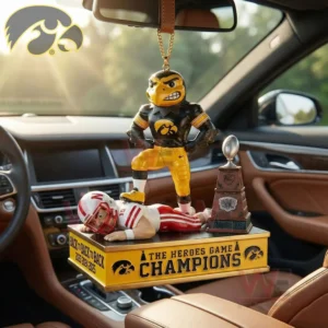 Iowa Hawkeyes mascot standing on a rival beside a trophy on a Heroes Game champions ornament inside a car.
