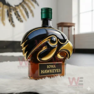 Black and gold hawk shaped Iowa bottle on white fur in a bright room!
