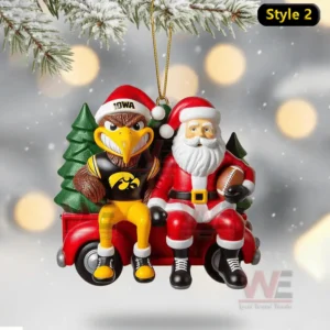 Iowa mascot and Santa sitting on a red truck ornament hanging from a snowy branch with glowing lights behind!