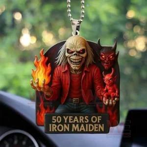 Car hanging ornament with Iron Maiden Eddie holding a flame and sitting in front of demon figures with a gold plaque reading fifty years of Iron Maiden.