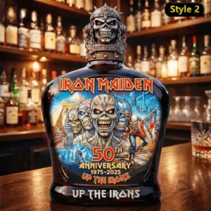 An Iron Maiden anniversary whiskey bottle with an alternate artistic label standing on a wooden bar surface!