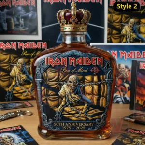 Iron Maiden 50th Anniversary Collector’s Whiskey Decanter 6 A whiskey decanter with Iron Maiden themed artwork and crown stopper is centered on a table with posters behind it!