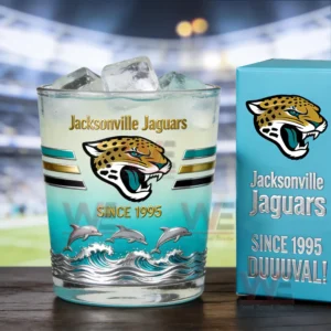 Jacksonville Jaguars themed whiskey glass with ice and light colored drink next to a branded collector box on a wooden surface!