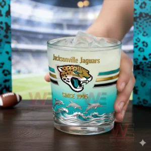 Jacksonville Jaguars Duuuval Since 1995 Whiskey Glass 3 Hand holding a Jacksonville Jaguars whiskey glass with ice and light drink in a football themed setting!
