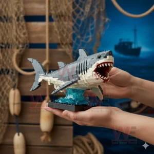A brick built shark model with wide open jaws mounted on a blue wave stand held carefully by hands!