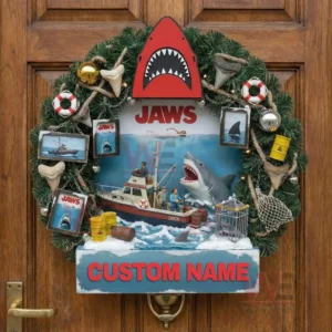 Christmas wreath with shark scene boat figures ocean waves framed images ropes life rings barrels and green pine foliage displayed on a wooden door!