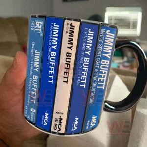Close view of a ceramic mug with Jimmy Buffett cassette album artwork held by hand in a casual indoor setting!