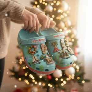 Turquoise Jimmy Buffett themed Christmas clogs with tropical charms held before a Christmas tree!