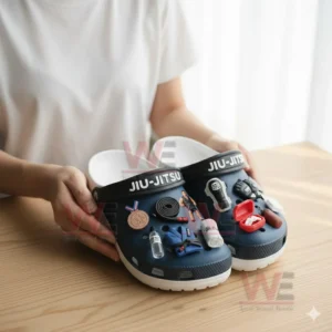 Jiu Jitsu Crocs Clogs with Charms 5 Hands presenting blue jiu jitsu clogs with multiple themed charms on a table!