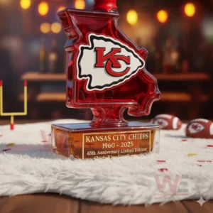 A red Chiefs anniversary bottle shaped like Missouri with a red cap displayed on a white rug in a festive football themed setting!