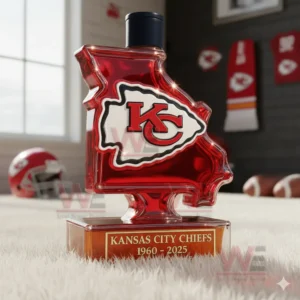 A Missouri shaped Chiefs bottle with a dark cap placed on a white rug among Chiefs themed items!