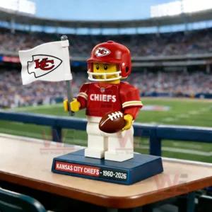 Red football figure holding a white flag and brown ball displayed on a base with a stadium scene behind!