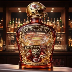 Kansas City Chiefs themed decanter bottle with a gold KC helmet topper and Arrowhead Stadium farewell label displayed on a bar counter with a liquor shelf background.