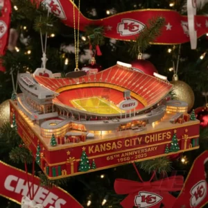 Kansas City Chiefs stadium anniversary ornament hanging on a Christmas tree surrounded by Chiefs themed decorations and glowing lights!