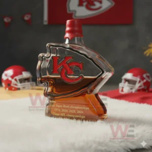 Arrow shaped whiskey bottle with amber liquor placed on a white fur surface with football decor!