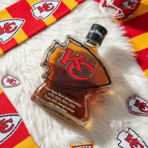 Arrow shaped whiskey bottle with amber whiskey resting on white fur with football team colors!