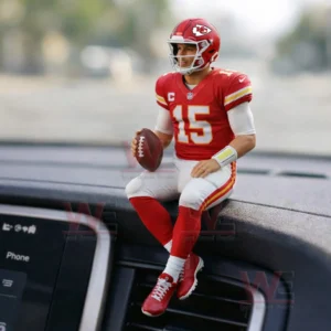 Kansas City Chiefs quarterback figure in a red number fifteen uniform sitting on a car dashboard holding a football!