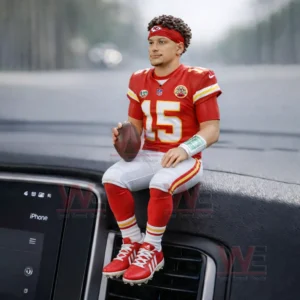 Kansas City Chiefs player figure in a red number fifteen uniform sitting on a car dashboard holding a football with curly hair and a headband!