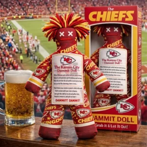 Kansas City Chiefs The Kansas City Dammit Doll 3 Kansas City Chiefs themed stress doll on a wooden surface next to its box and a beer with a football crowd filling the stadium background!
