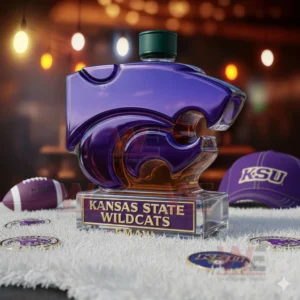 Kansas State Wildcats Custom Whiskey Bottle 7 A purple Wildcats bottle resting on a fluffy surface with sports themed decor surrounding it!