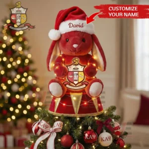 Red plush bunny in Santa hat with Kappa Alpha Psi crest used as a Christmas tree topper among red and white ornaments!