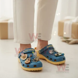 Kenny Chesney Crocs Clogs with Charms 5 Person wearing blue Kenny Chesney clogs with beach music charms in a warm indoor setting!