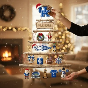 A person holding a rustic wooden branch Christmas wall tree decorated with Kentucky Wildcats themed ornaments in a festive living room!