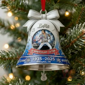 The image displays a silver and blue Elvis themed anniversary bell ornament hanging on a Christmas tree with festive details and a guitar charm.