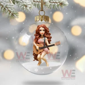 The image displays a festive ornament showing a woman in a pink dress holding a guitar within a snowy glass globe.