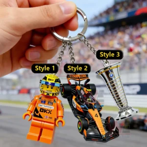 Racing keychain with driver figure race car and trophy dangling from a metal ring above a motorsport track scene!
