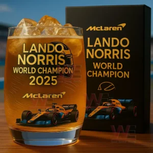Glass with Lando Norris world champion 2025 McLaren themed text and race car illustration filled with iced amber drink beside a matching black gift box!