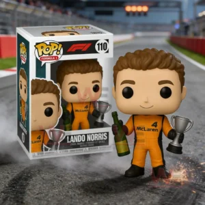 Lando Norris McLaren collectible figure holding a trophy and bottle standing on a racetrack beside a Lando Norris display box with a blurred race circuit background!