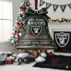 A silver Raiders anniversary bell ornament hanging in a holiday themed room.