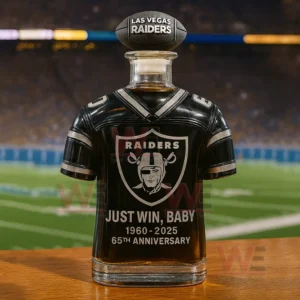 Las Vegas Raiders themed whiskey bottle shaped like a football jersey with logo and text standing on a table in front of a stadium field!